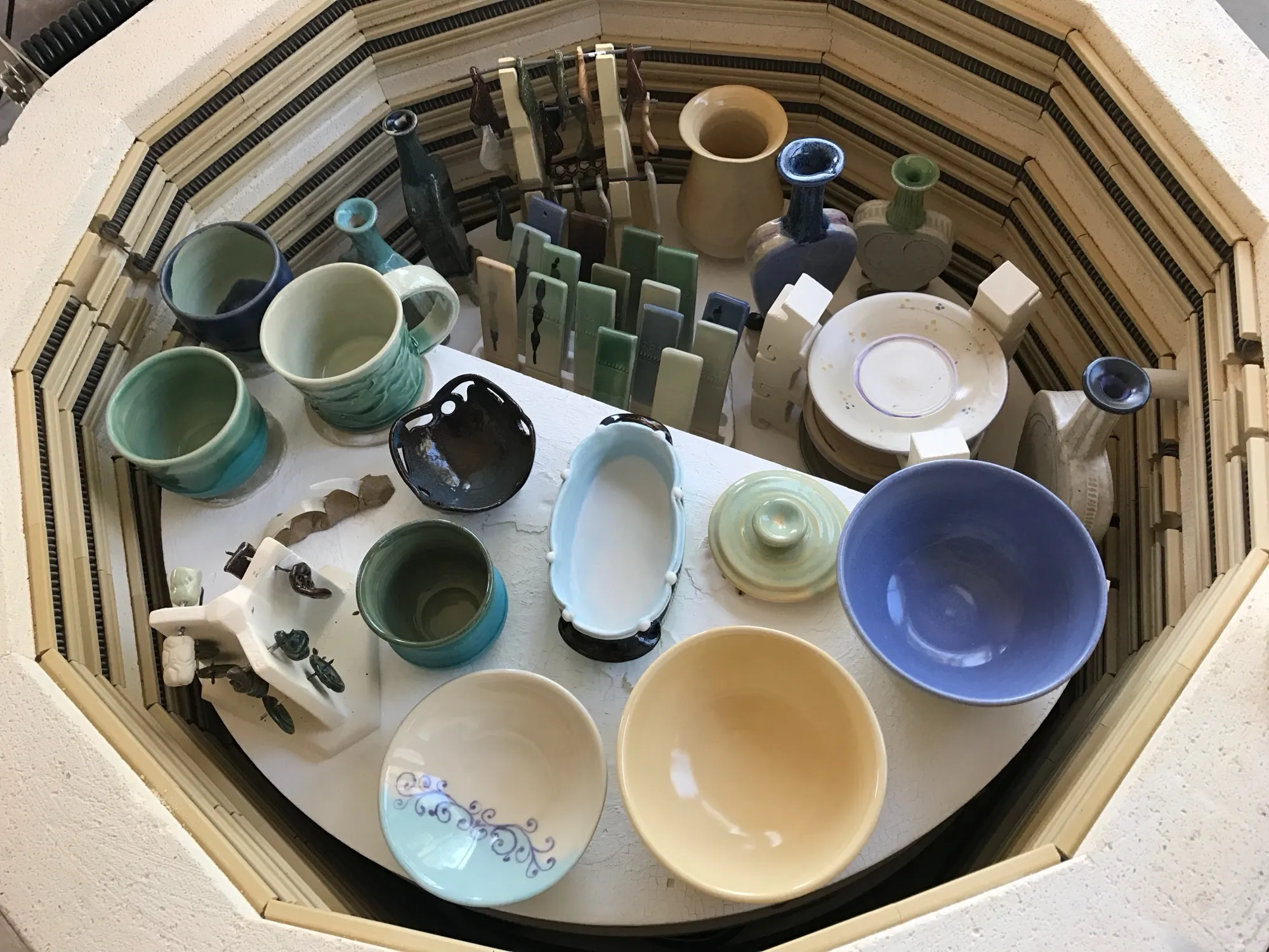 A kiln load of glazed cups and bowls