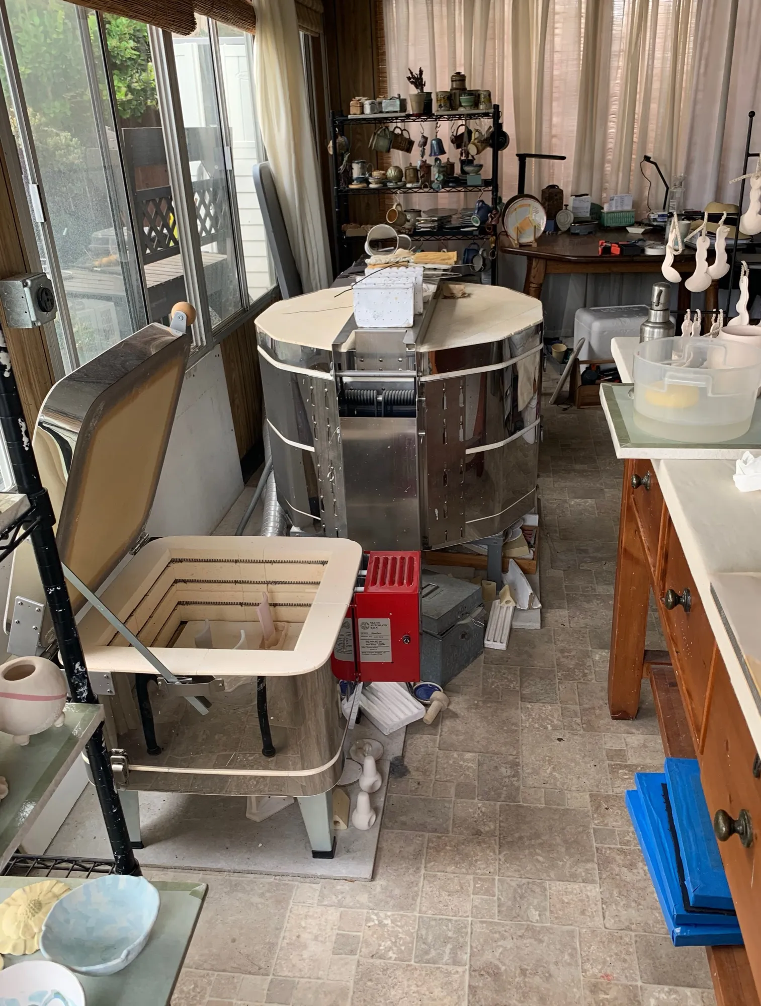 The pottery studio with kilns, wheel, and work tables